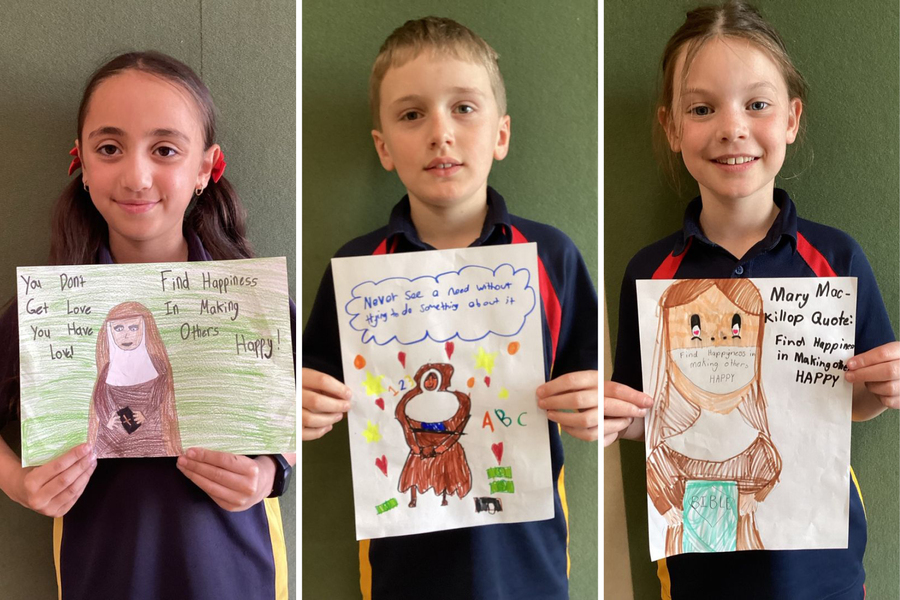 RELIGION > Estella, Alfie and Ruby with their posters about St Mary MacKillop.