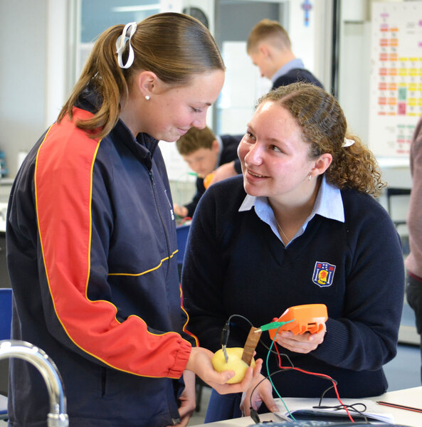 SCIENCE > Connie and Issy testing the energy created by fruit and vegetables.