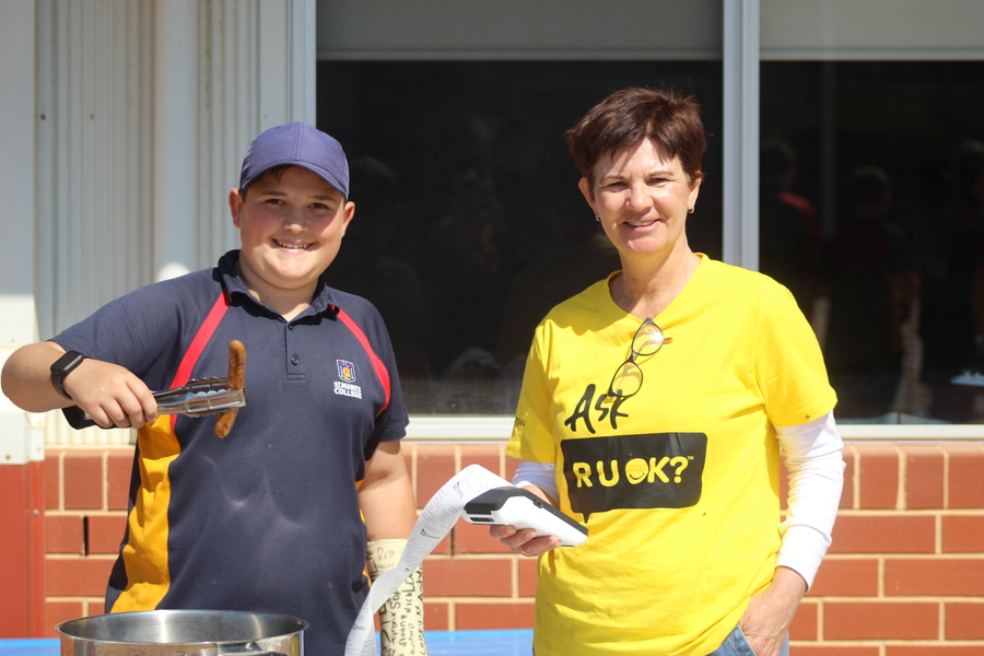 Zac and Mrs Gibson running the sausage sizzle.