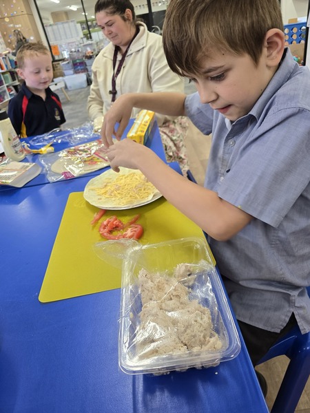 COOKING > Lawson enjoying cooking group with Mrs Donnellan and Miss Carslake.