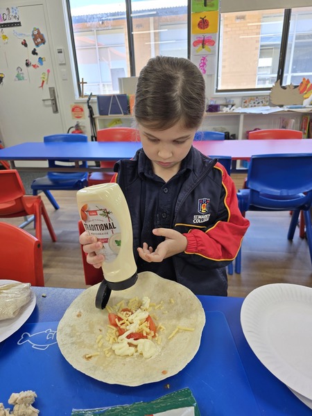 COOKING > Calliope enjoying cooking group with Mrs Donnellan and Miss Carslake.