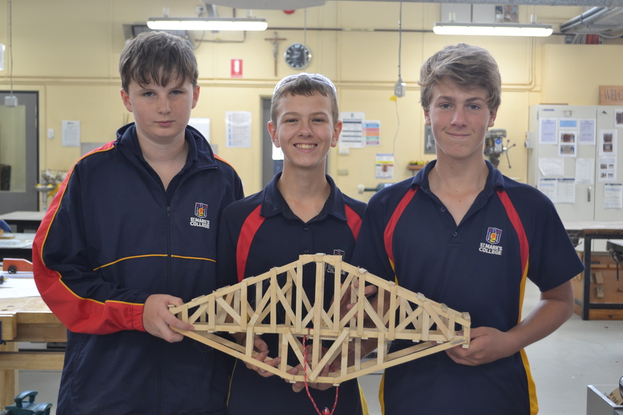 DESIGN + TECHNOLOGY > Year 7 students constructed bridges and tested their strength with weights, the strongest bridge holding 61kg!