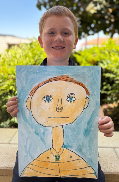 ART > Year 2 student Zeke with his self portrait.