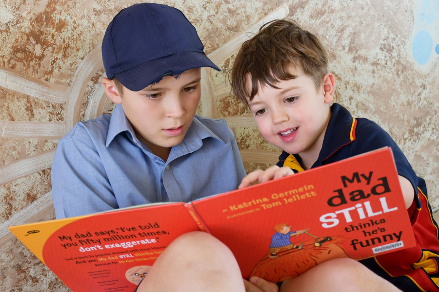 BUDDIES > Year 6 student Hugo shares a story with his Reception Buddy Callan.