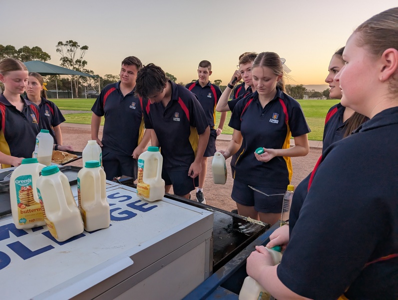 RELIGION > Year 12 students enjoying a cooked breakfast before their excursion to Port Germein.